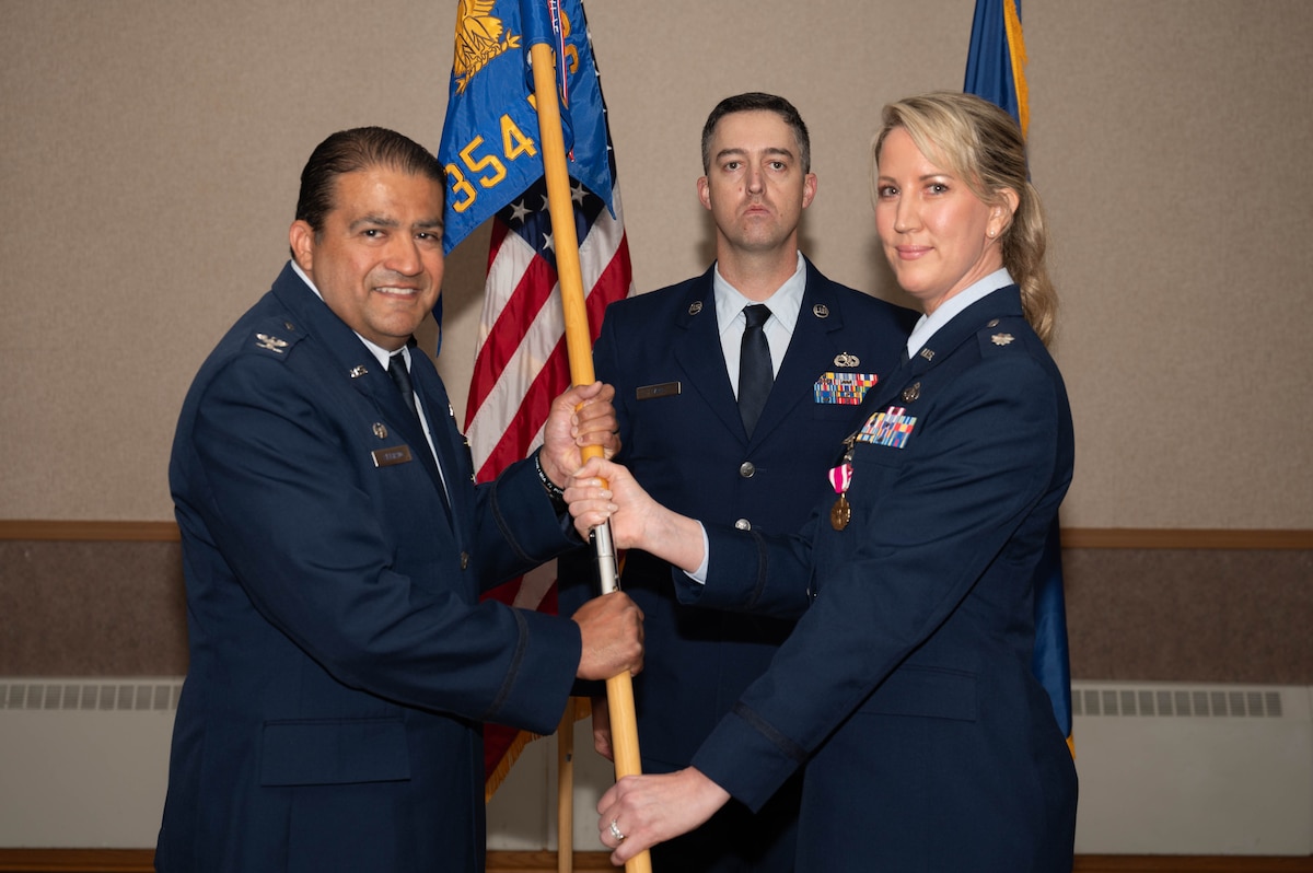 U.S. Air Force Col. Antonio Alvarado (left), 354th Mission Support Group commander, receives the guidon from Lt. Col. Amanda Henry, 354th Force Support Squadron outgoing commander, during a change of command ceremony at Eielson Air Force Base, Alaska, July 2, 2024.