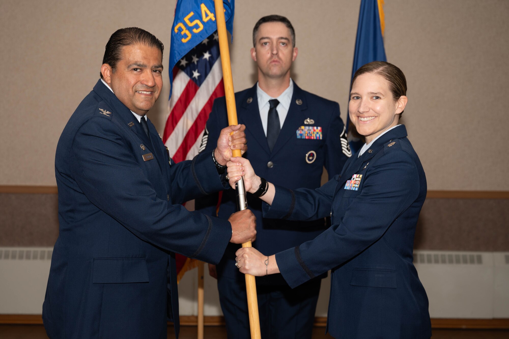 U.S. Air Force Col. Antonio Alvarado (left), 354th Mission Support Group commander, relinquishes the guidon to Lt. Col. Michelle Ground, 354th Force Support Squadron incoming commander, at Eielson Air Force Base, Alaska, July 2, 2024.