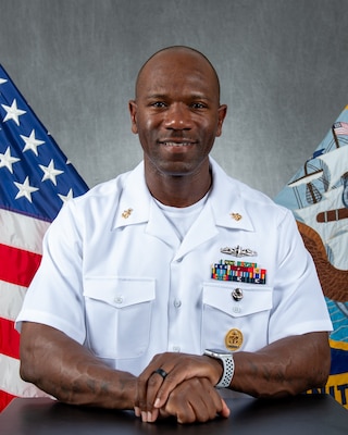 Senior Chief poses for official portrait in dress whites