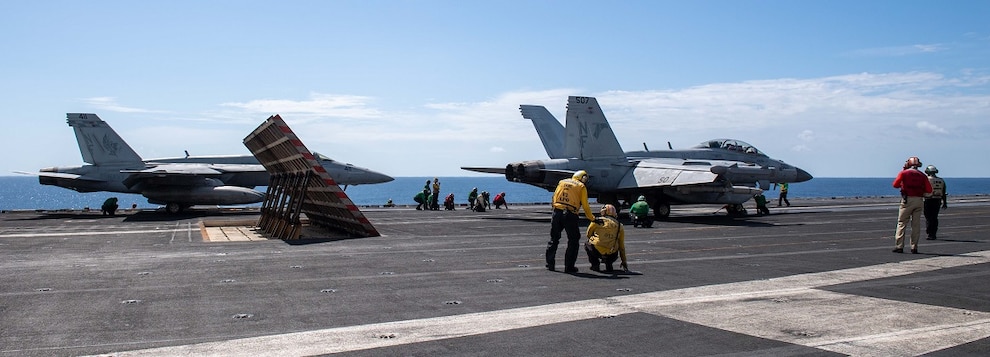 Sailors prepare to launch an F/A-18E Super Hornet, attached to the Dambusters of Strike Fighter Squadron (VFA) 195, and an EA-18G Growler, attached to the Shadowhawks of Electronic Attack Squadron (VAQ) 141, from the flight deck of the U.S. Navy’s only forward-deployed aircraft carrier, USS Ronald Reagan (CVN 76).