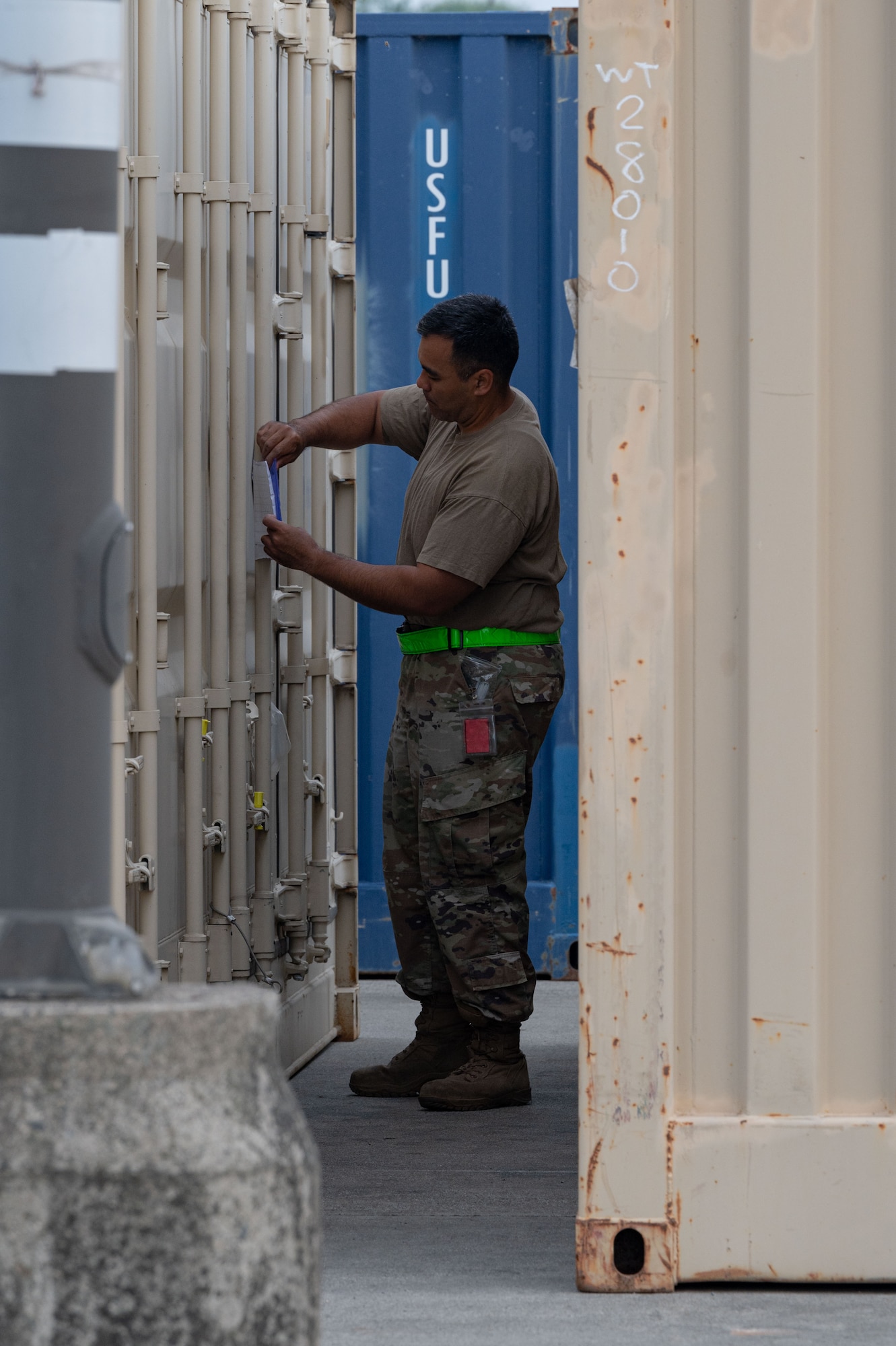 Tech. Sgt. Francisco Nieves, 8th Logistics Readiness Squadron cargo movement section chief, labels an intermodal container during a munitions retrograde.