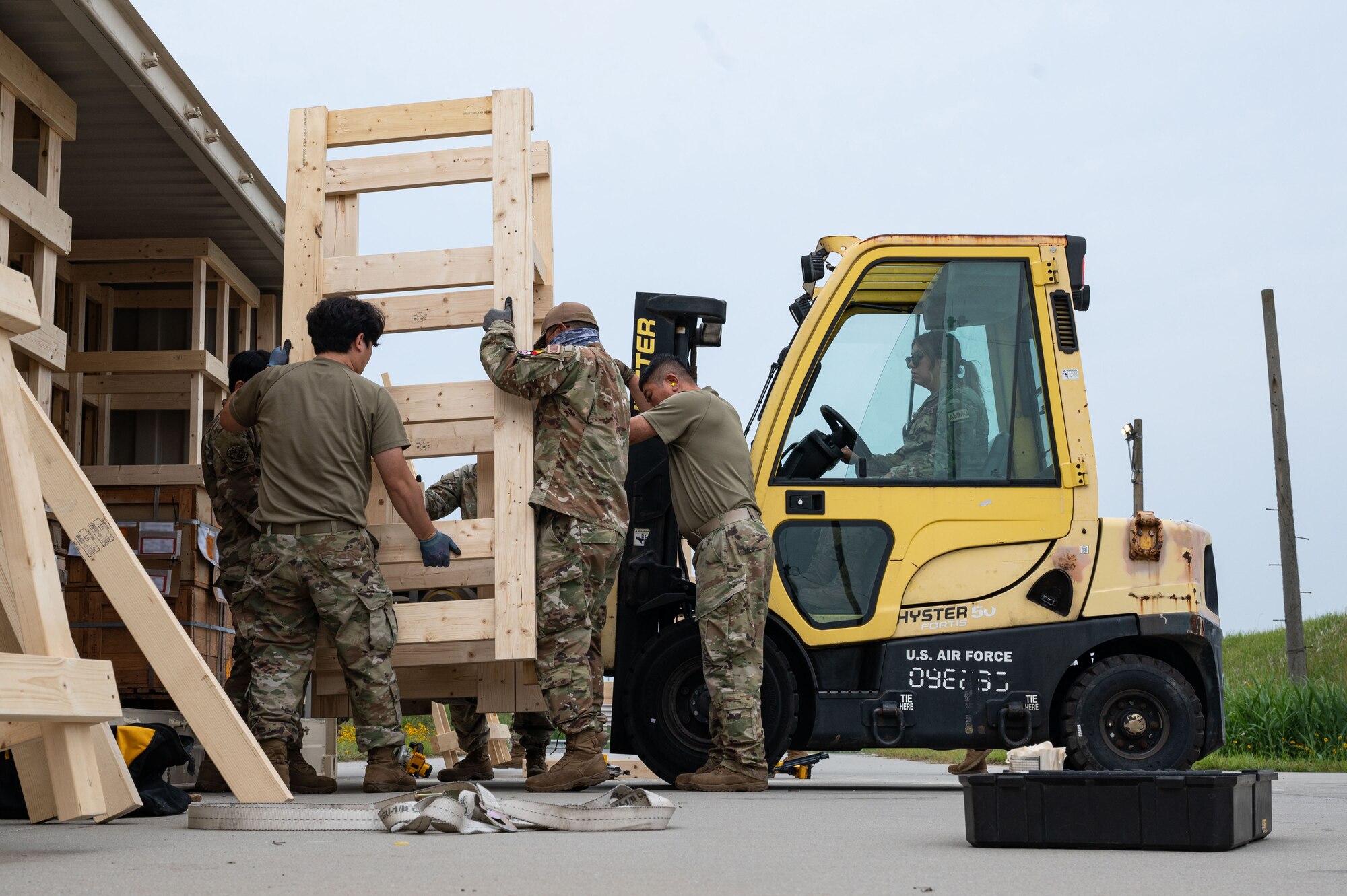 Local nationals assigned to the 8th Maintenance Squadron, load an asset into an intermodal container during a munitions retrograde.
