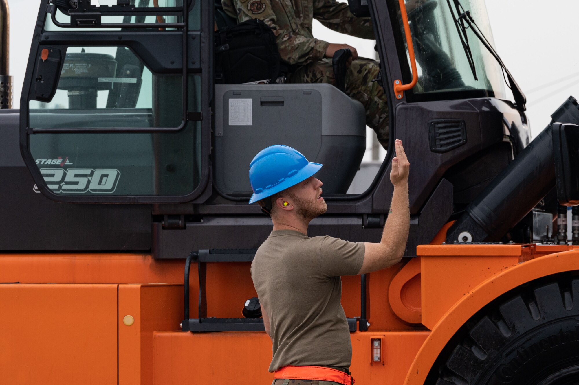 U.S. Air Force Staff Sgt. Jimmy Smith, 8th Maintenance Squadron stockpile management crew chief, marshals a 50K forklift during a munitions retrograde.