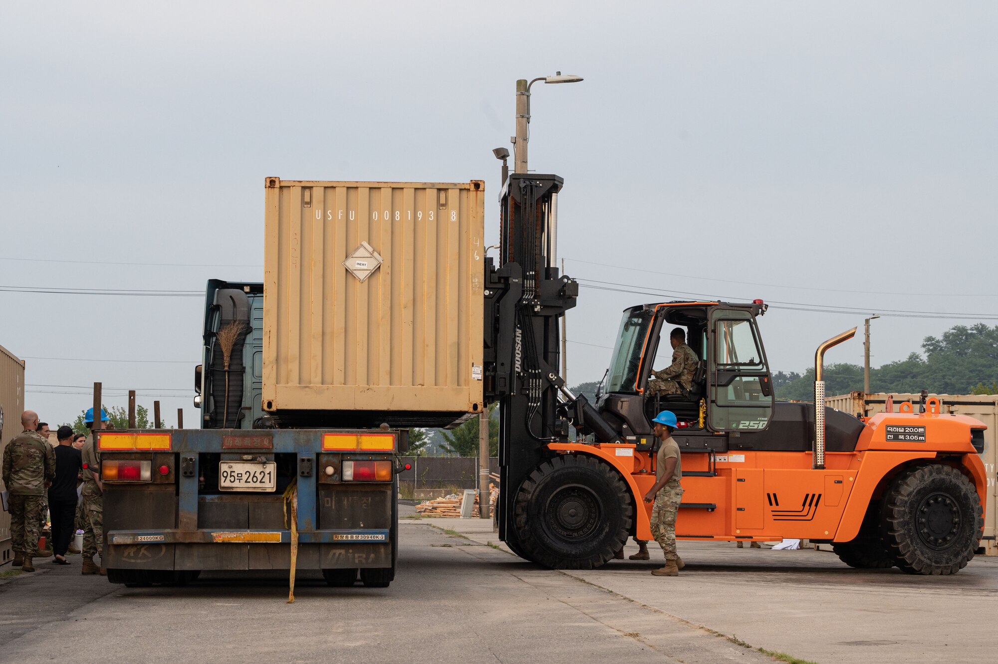 Members assigned to the 8th Maintenance Squadron load an intermodal container onto a truck during a munitions retrograde.