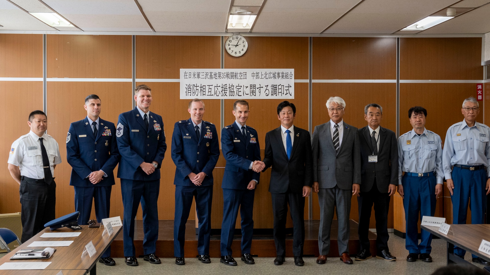 Members from Misawa Air Base, Tohoku town, and the Chubu-Kamikita Regional Business Association Fire Department pose for a photo with the Memorandum of Understanding International (MoUI) during the Fire Protection Agreement ceremony at Tohoku Town, Japan, July 1, 2024.