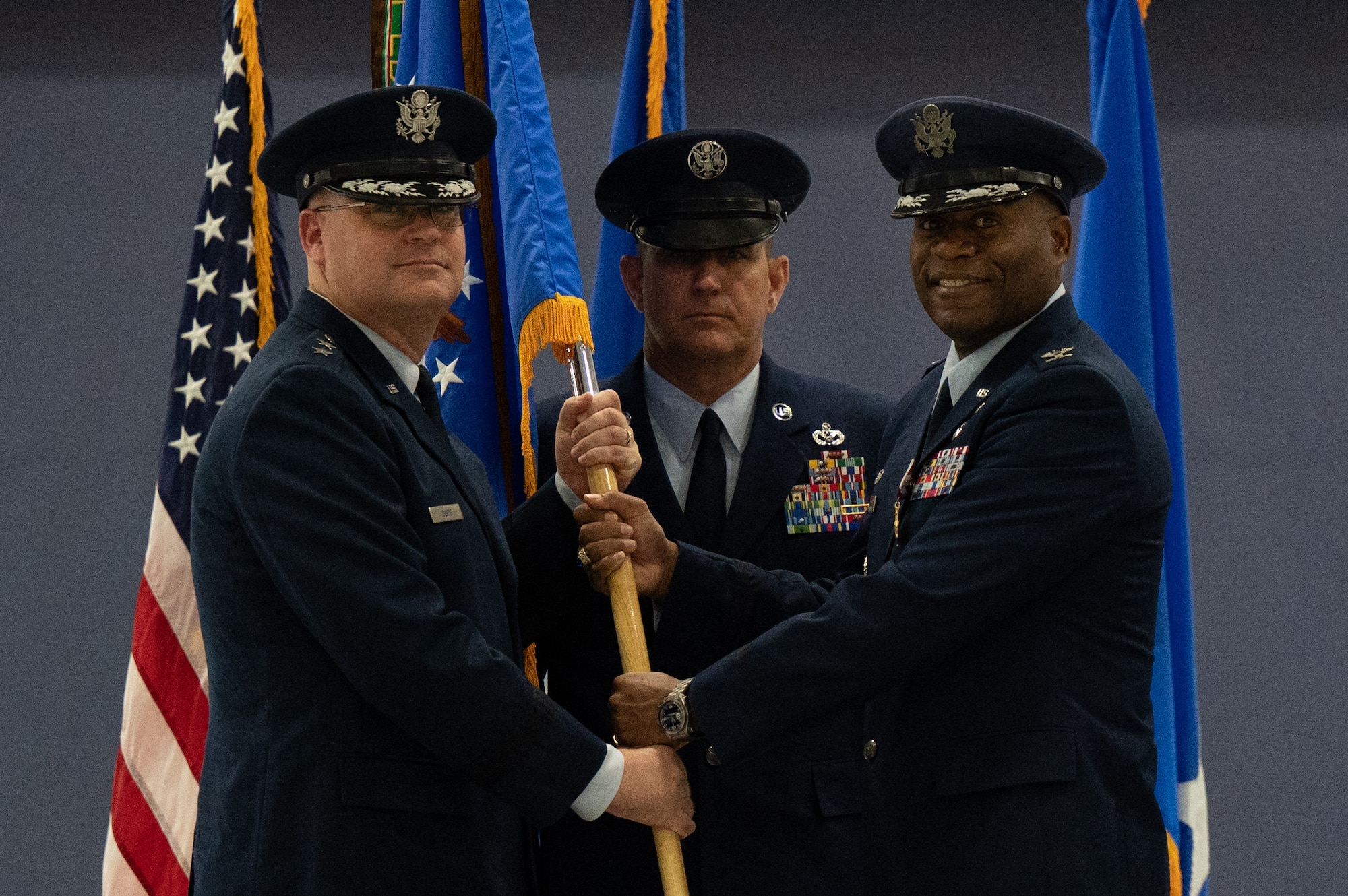 U.S. Air Force Maj. Gen. Daniel A. DeVoe, left, receives the guidon from Col. Todd E. Randolph as he relinquishes command of the 316th Wing