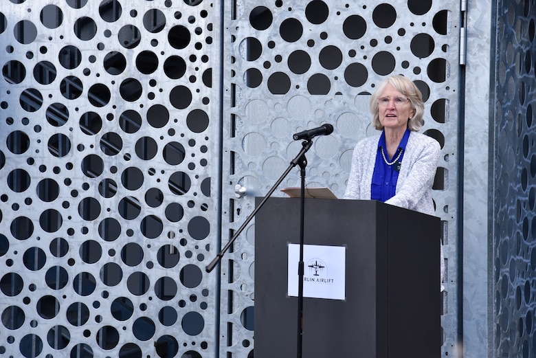 Denise Williams, daughter of the late Col. Gail S. Halvorsen, speaks at a ceremony dedicating the new air traffic control tower on the Clay Kaserne portion of U.S. Army Garrison Wiesbaden in her father’s name June 15, 2024. Members of the U.S. Army Garrison Wiesbaden community, U.S. Army Corps of Engineers personnel and several Berlin Airlift time witnesses and time witness family members joined together for the ceremony officially dedicating the facility as the Col. Gail S. Halvorsen Tower. (U.S. Army photo by Chris Gardner)