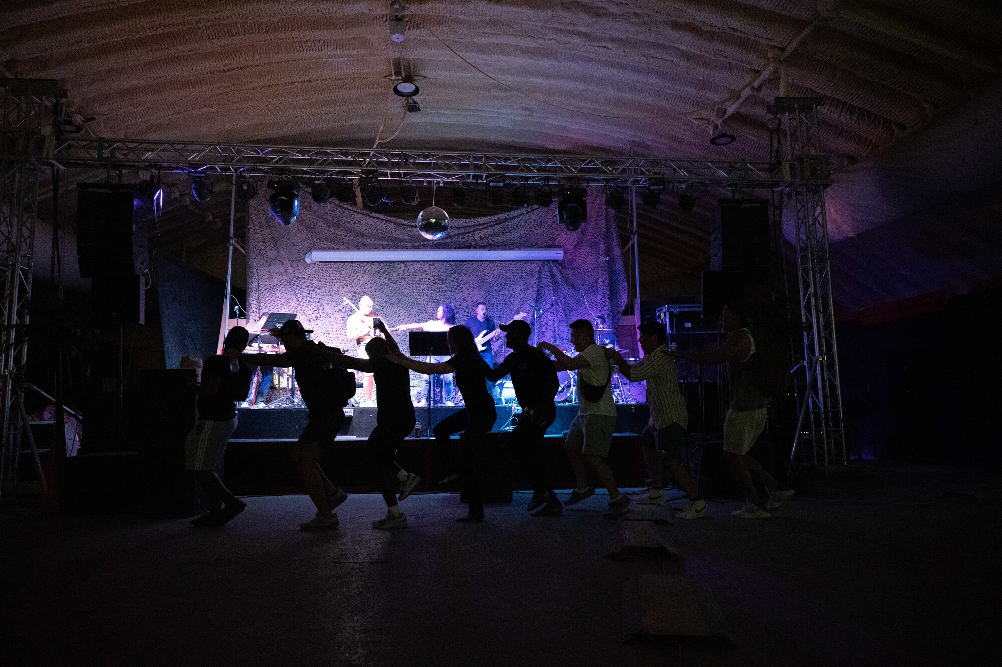 U.S. Airmen assigned to the AFCENT Band perform a concert at an undisclosed location within the U.S. Central Command area of responsibility on June 22, 2024. The AFCENT Band is a versatile group of musicians that showcase a wide variety of music ranging from Top 40, pop, rock, R&B, country, and jazz. (U.S. Air Force photo)