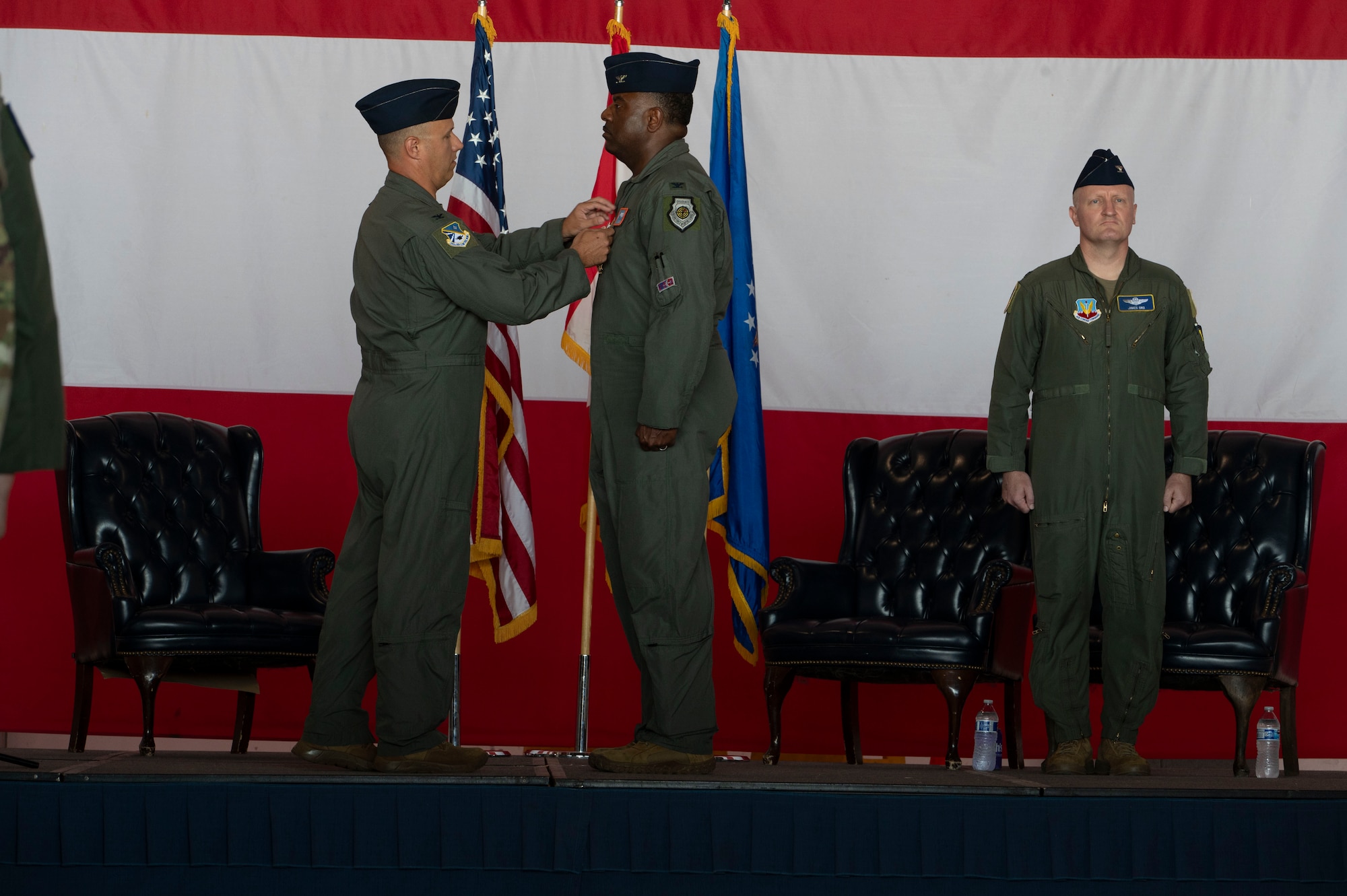 Col. Kenneth Voigt, 552nd Air Control Wing commander, pins Col. Kendrick Carroll, former 552nd Training Group commander, with the Legion of Merit award for his exceptional meritorious conduct as the former 552nd TRG commander