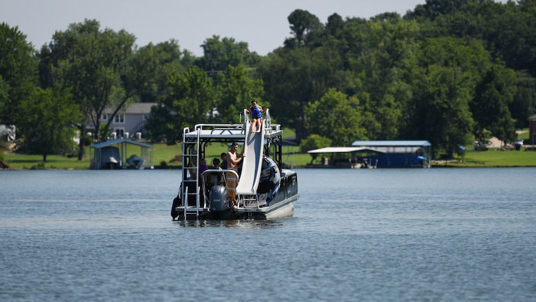 A young lady prepares to slide down a slide on a boat into the water at Old Hickory Lake.