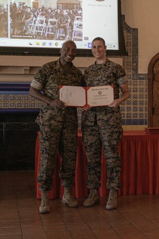 U.S. Marine Corps Brig. Gen. James A. Ryans II, commanding general, Marine Corps Recruit Depot San Diego and Western Recruiting Region presents a certificate of recognition to Staff Sgt. Melissa Karnath, Communication Strategy and Operations outreach chief, Headquarters and Service Battalion, at MCRD San Diego, California, June 25, 2024. Within the past year, over 35 Marines and Sailors aboard MCRD San Diego have furthered their education with the help of tuition assistance. (U.S. Marine Corps photo by Lance Cpl. Alexandra M. Earl)