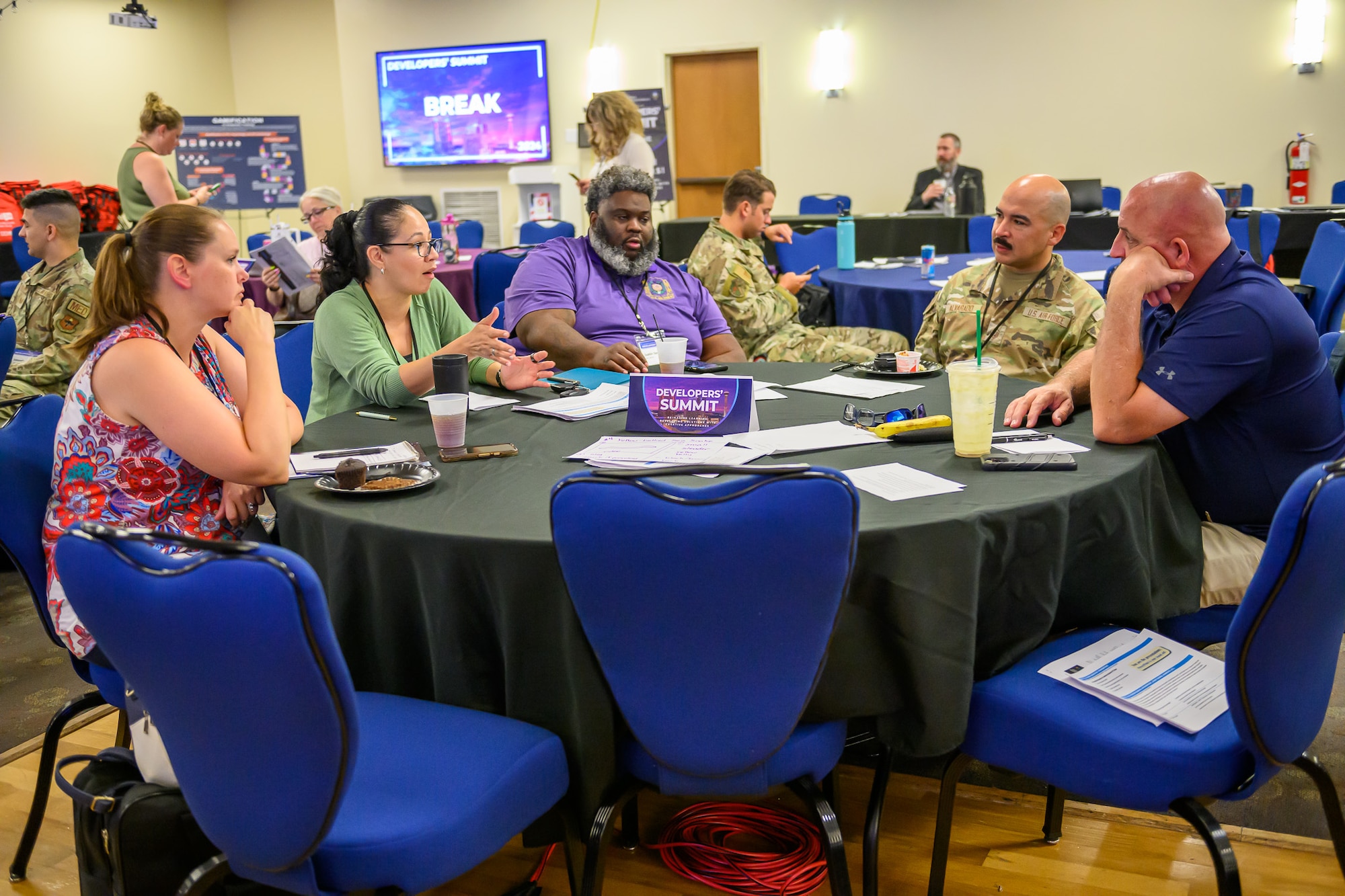Shots of individuals communicating and participating in the Developers' Summit 2024