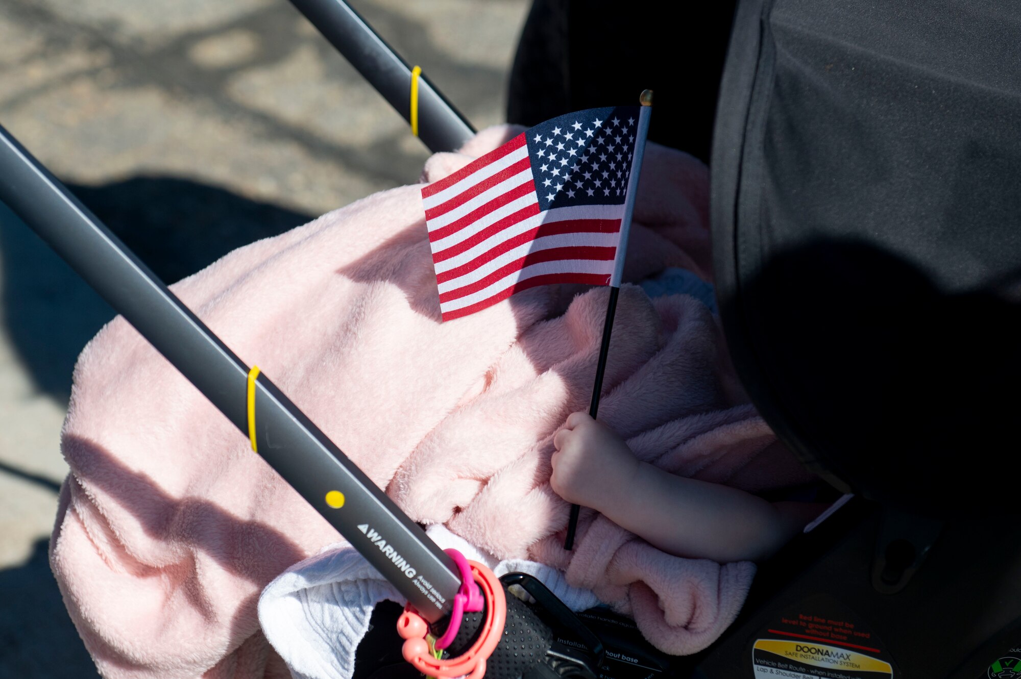 An American flag is seen in the hand an infant of a new U.S. citizen.