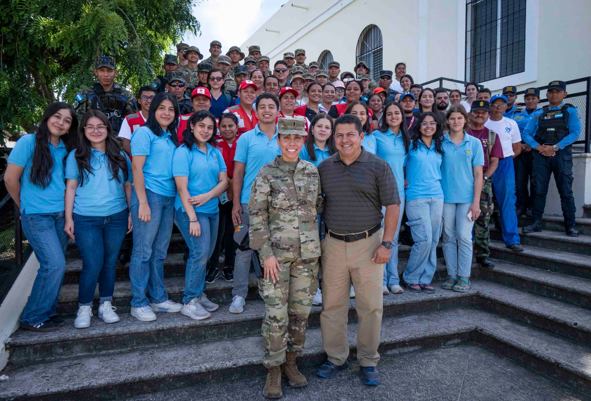 A photo of a large group of people smiling at the camera.