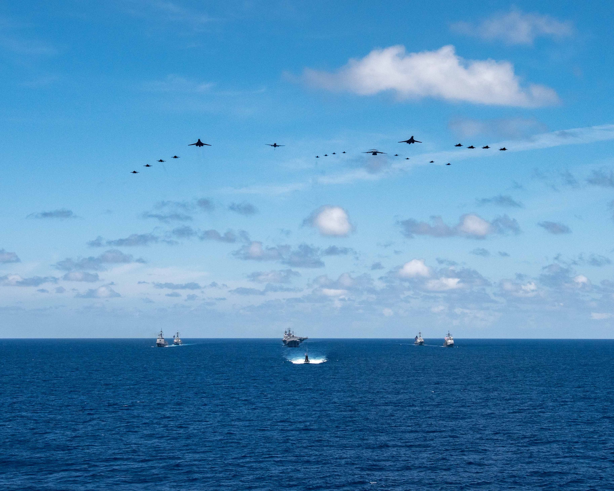 240607-N-AT887-1529 PHILIPPINE SEA (June 7, 2024) The U.S. Navy’s only forward-deployed aircraft carrier, USS Ronald Reagan (CVN 76), steams in formation with the flagship of U.S. 7th Fleet, USS Blue Ridge (LCC 19), Ticonderoga-class guided-missile cruiser, USS Robert Smalls (CG 62), Arleigh Burke-class guided-missile destroyers, USS Higgins (DDG 76) and USS Rafael Peralta (DDG 115), along with Japanese ships, a Taigei-class attack submarine, Izumo-class helicopter carrier, JS Izumo (DDH 183), and Maya-class guided-missile destroyer, JS Haguro (DDG 180), as four F/A-18 Super Hornets attached to Carrier Air Wing 5, two U.S. Air Force (USAF) B-1 Lancer heavy bombers, four USAF F-22 Raptor fighter aircraft, four USAF F-16 Falcon fighter aircraft, two Japan Air Self-Defense Force (JASDF) Mitsubishi F-2 multirole fighters, two JASDF Mitsubishi F-15 Eagle air superiority fighters, one USAF C-17 Globemaster aircraft, and one USAF KC-46 Pegasus tanker conduct a formation fly over in support of Valiant Shield 2024 in the Philippine Sea, June 7. Exercises such as Valiant Shield allow the Indo-Pacific Command Joint Forces the opportunity to integrate forces from all branches of service and with our allies to conduct precise, lethal, and overwhelming multi-axis, multi-domain effects that demonstrate the strength and versatility of the Joint Force and our commitment to a free and open Indo-Pacific. (U.S. Navy photo by Mass Communication Specialist Seaman Kevin Steffanson)
