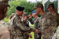 Military personal greet and shake hands