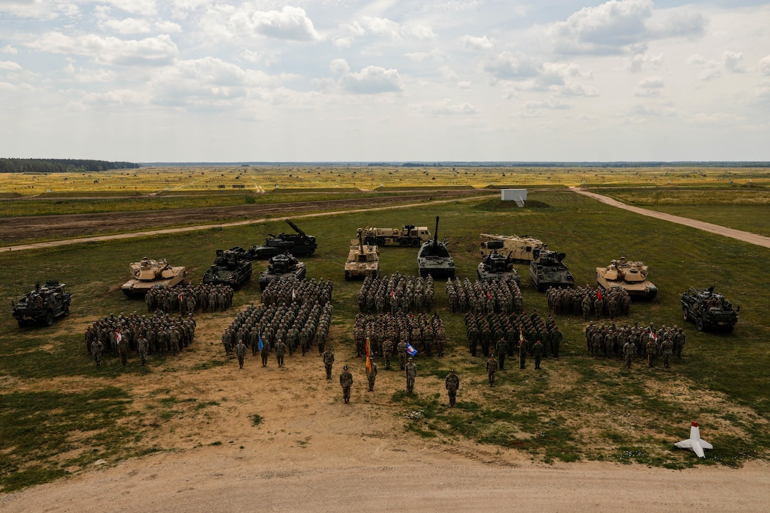 Soldiers of the Forward Land Forces Battle Group Poland made up 2nd Battalion, 12th Cavalry Regiment, 1st Armored Brigade Combat Team, 1st Cavalry Division, along with 13th Croatian Contingent “Iron Storm,” Romanian Air Defense “Sky Guardians” and United Kingdom Eagle Troop pose for a group photo in Bemowo Piskie Training Area, Poland, June 28, 2024. The 1st Cavalry Division’s mission is to engage in multinational training and exercises across the continent, strengthening interoperability with NATO allies and regional security partners, which provides competent and ready forces to V Corps, America’s forward-deployed corps in Europe. (Photo by Sgt. Cecil Elliott II)