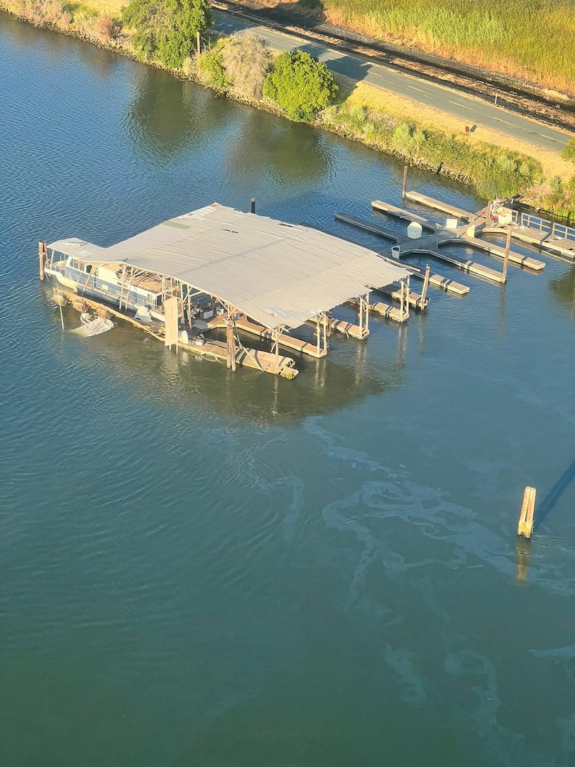 An aerial view of a sheen is seen in a waterway, taken from a Coast Guard helicopter.