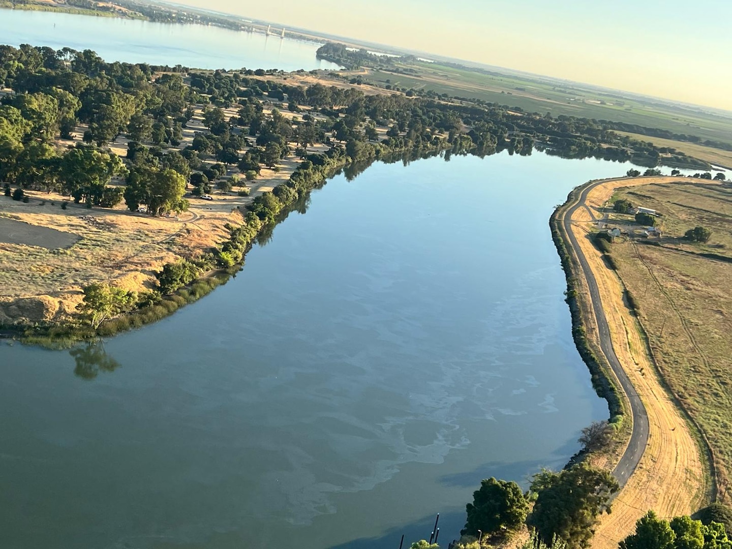 An aerial view of a sheen is seen in a waterway, taken from a Coast Guard helicopter.