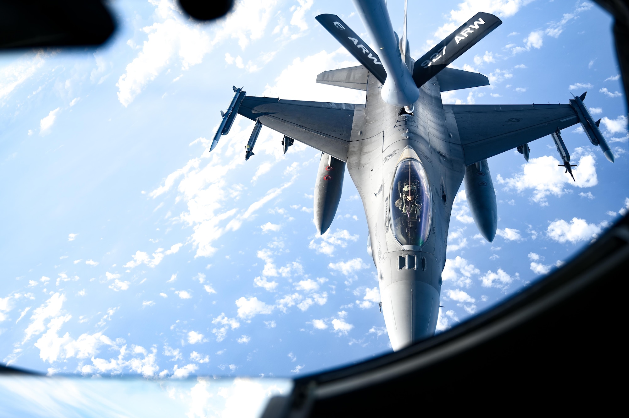 A pilot performs an aerial refueling.