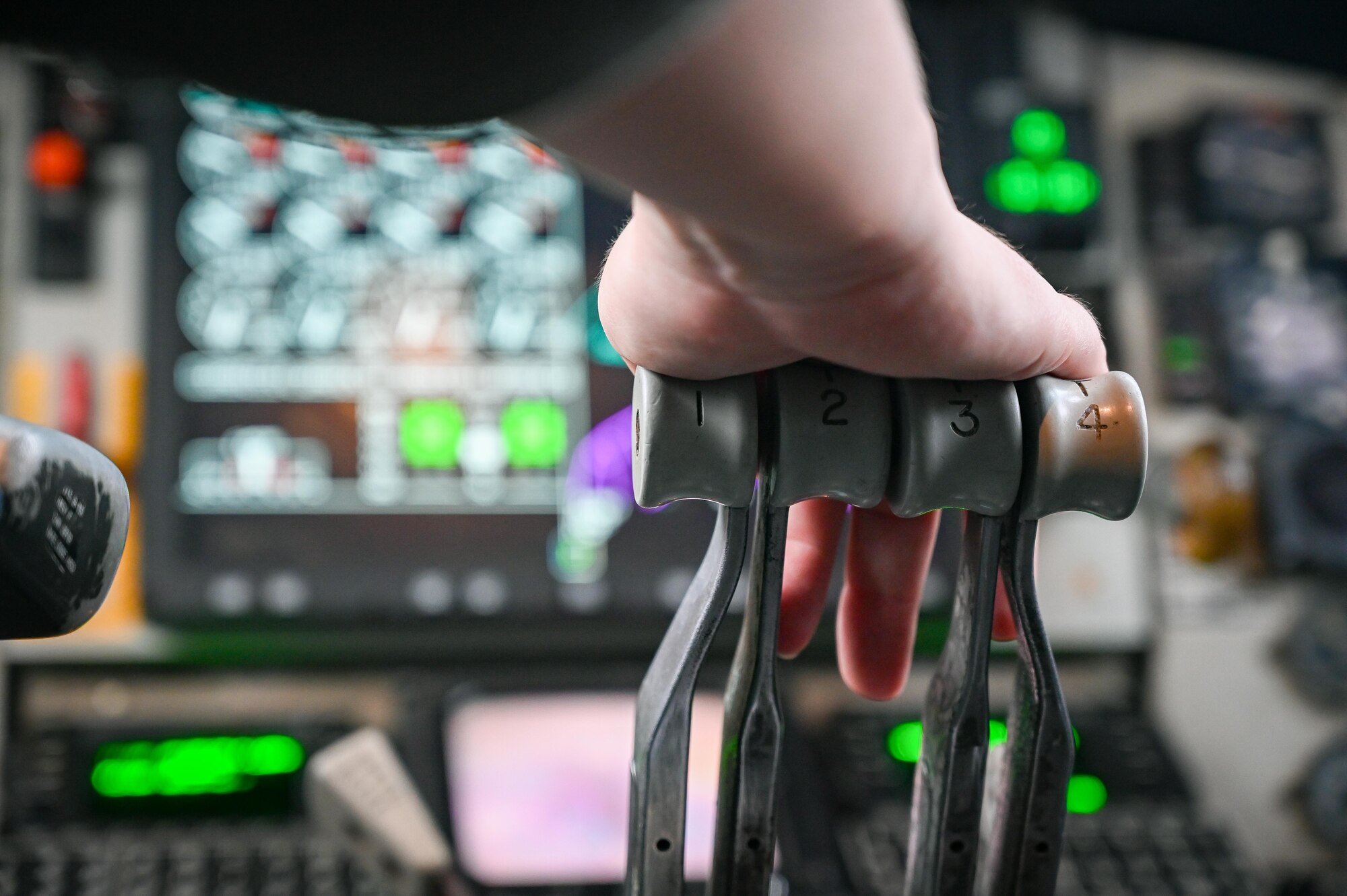 A pilot pushes a throttle forward.