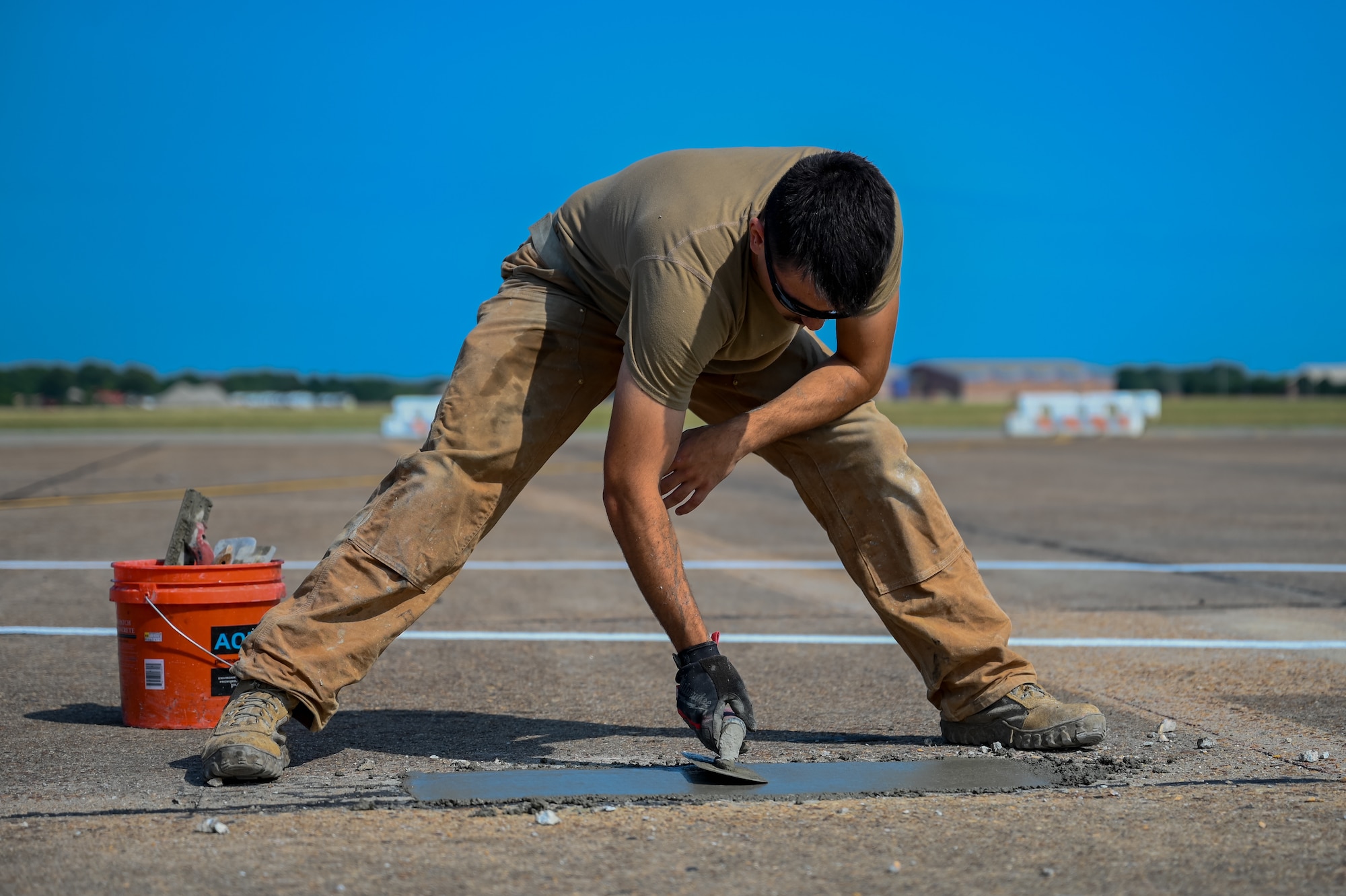 Airmen fix the flight line runway