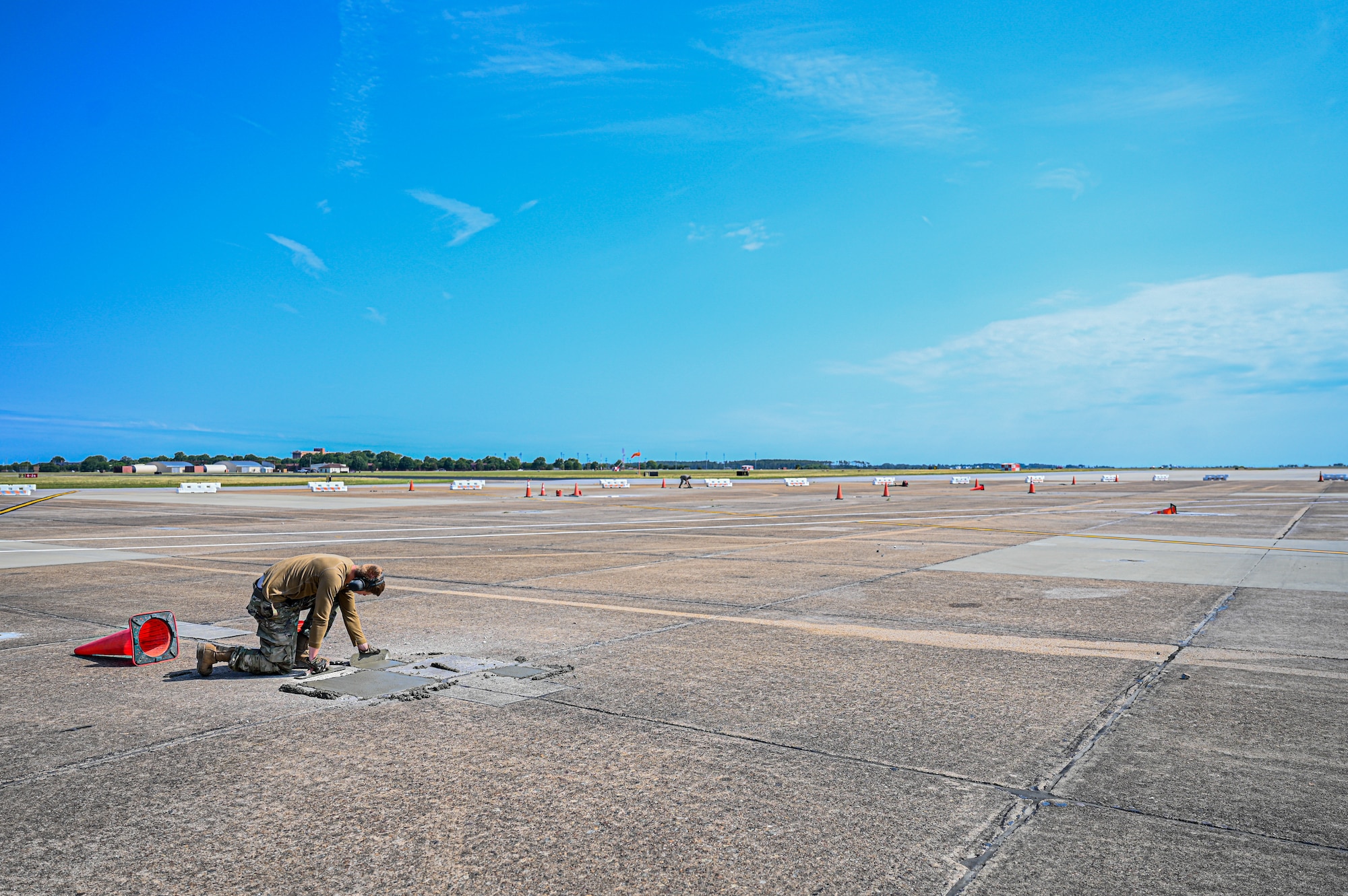 Airmen fix the flight line runway