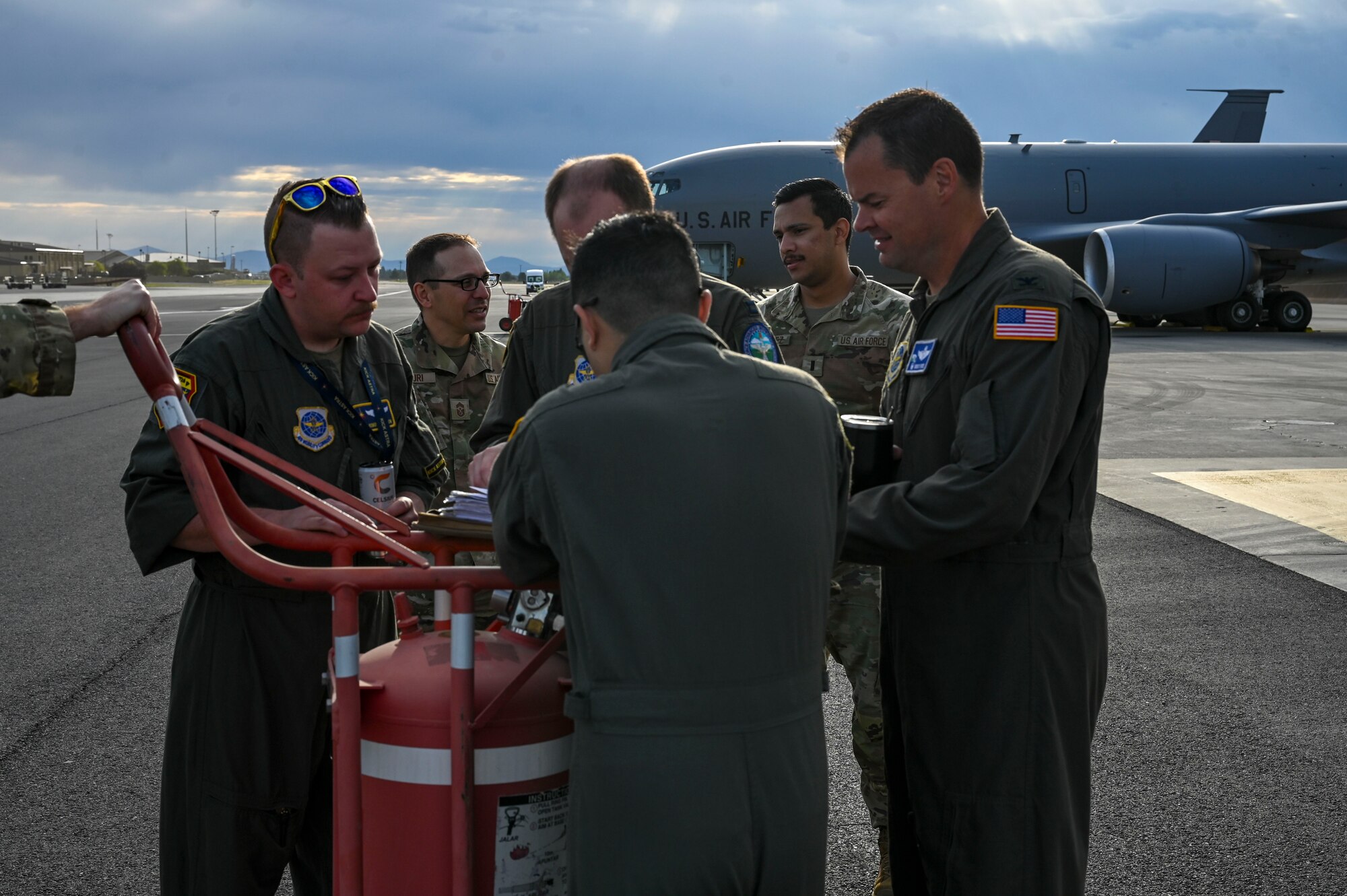 An aircrew looks over a briefing binder on the flightline.