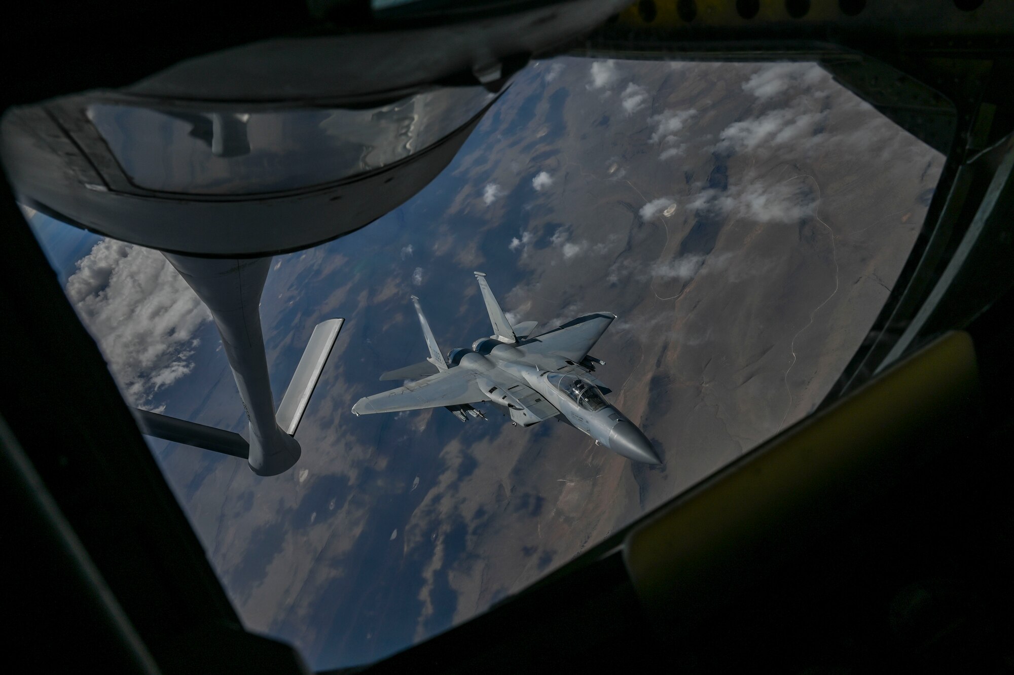 An F-15C Eagle is being refueled by a KC-135 Stratotanker.