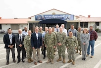 Dr. Peter Adair (center left), technical director of NSWC Panama City Division, poses for a group photo with NSWC Port Hueneme Division (PHD) Commanding Officer Capt. Tony Holmes (center) and other command and department leaders prior to a briefing, May 2. It was Adair’s last day of his swap with NSWC PHD Technical Director Jeff Koe, who spent the week in Panama City. (U.S. Navy photo by Dana Rene White/Released)
