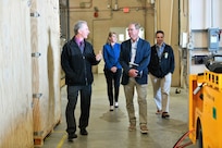 Gene Scampone, NSWC Port Hueneme Division’s (NSWC PHD) Mission Package Support Facility (MPSF) manager (front left), takes Dr. Peter Adair, technical director of NSWC Panama City Division (front right) on a tour of the MPSF on April 30, along with Susan Vargas, NSWC PHD deputy chief of staff (behind left), and Andrew Payor, MPSF sustainment principal assistant program manager. The MPSF provides assembly and sustainment to littoral combat ship mission packages. (U.S. Navy photo by Dana Rene White/Released)