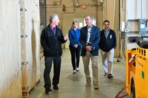 Gene Scampone, NSWC Port Hueneme Division’s (NSWC PHD) Mission Package Support Facility (MPSF) manager (front left), takes Dr. Peter Adair, technical director of NSWC Panama City Division (front right) on a tour of the MPSF on April 30, along with Susan Vargas, NSWC PHD deputy chief of staff (behind left), and Andrew Payor, MPSF sustainment principal assistant program manager. The MPSF provides assembly and sustainment to littoral combat ship mission packages. (U.S. Navy photo by Dana Rene White/Released)