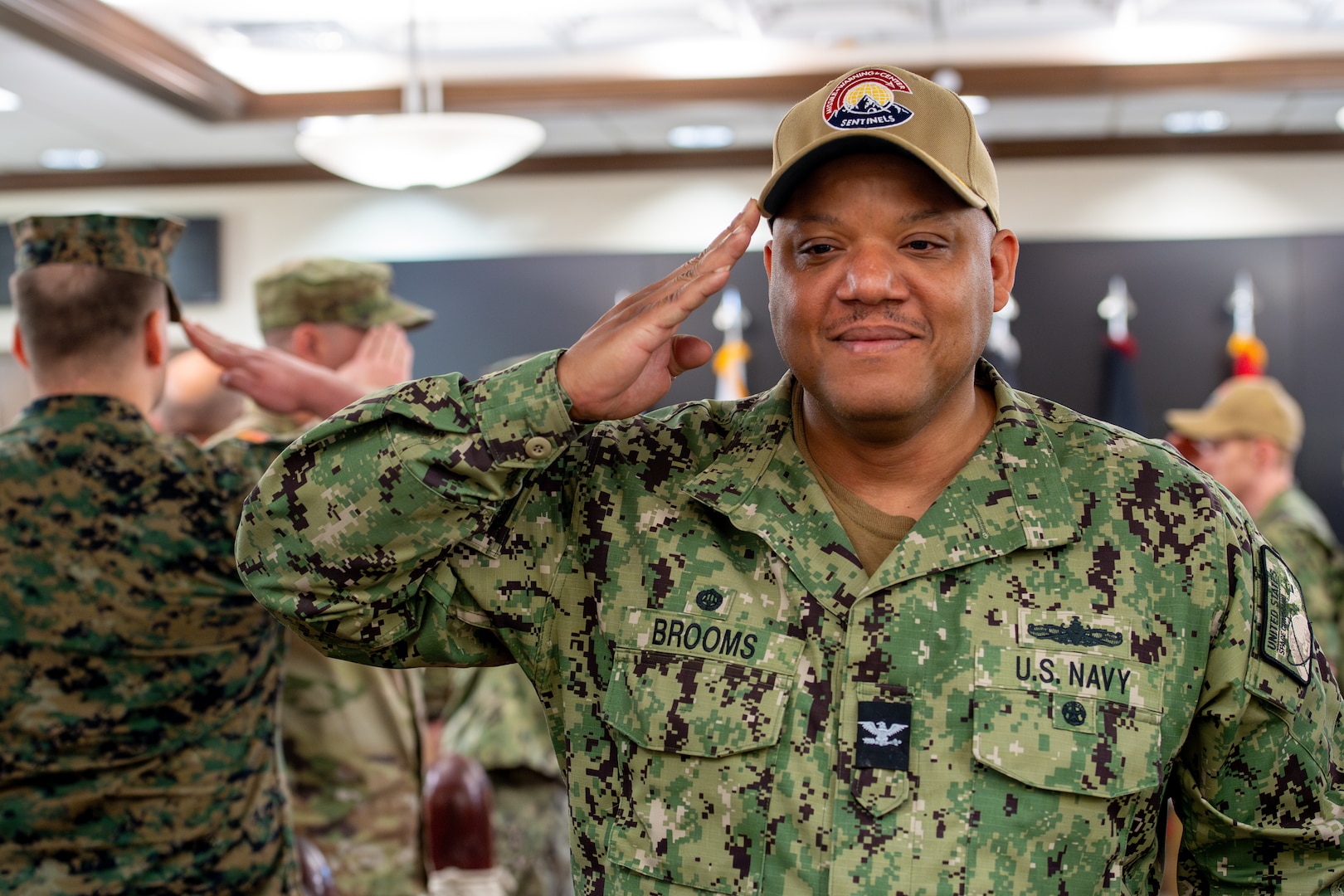 Man in Navy uniform salutes