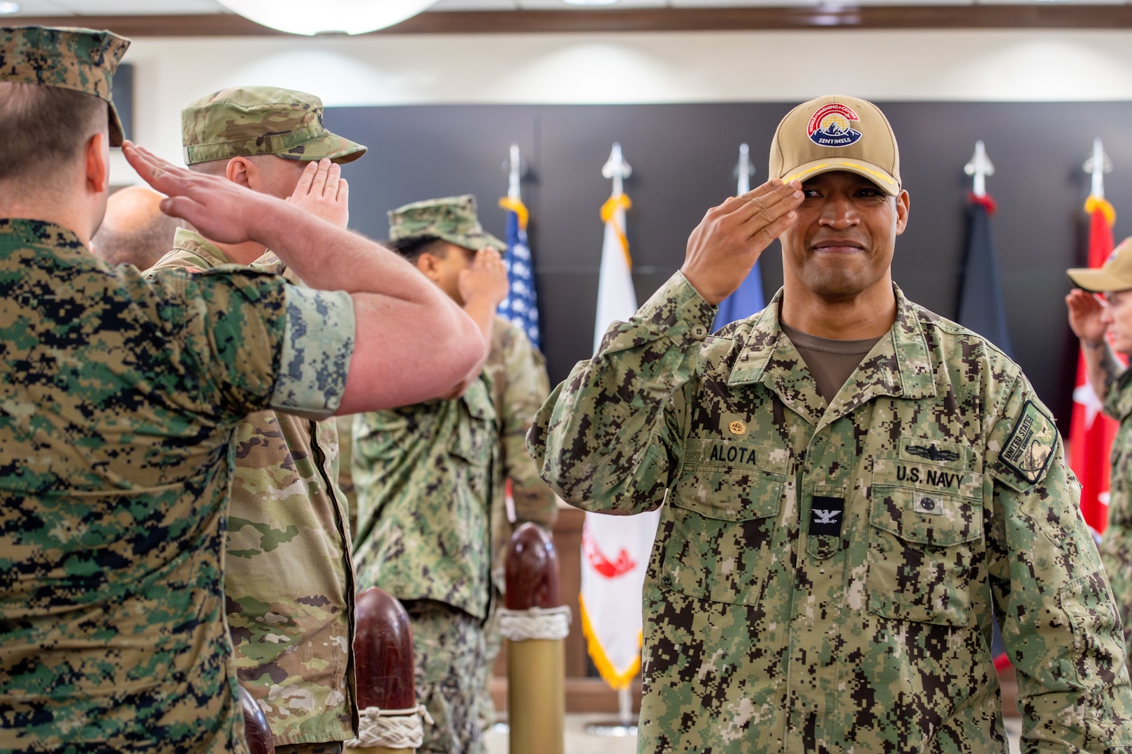 Man in navy uniform salutes