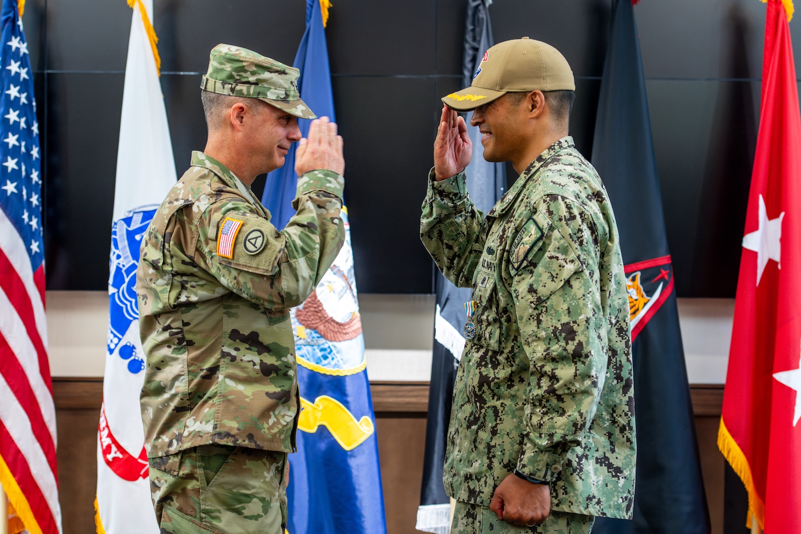 Two men in uniform salute each other