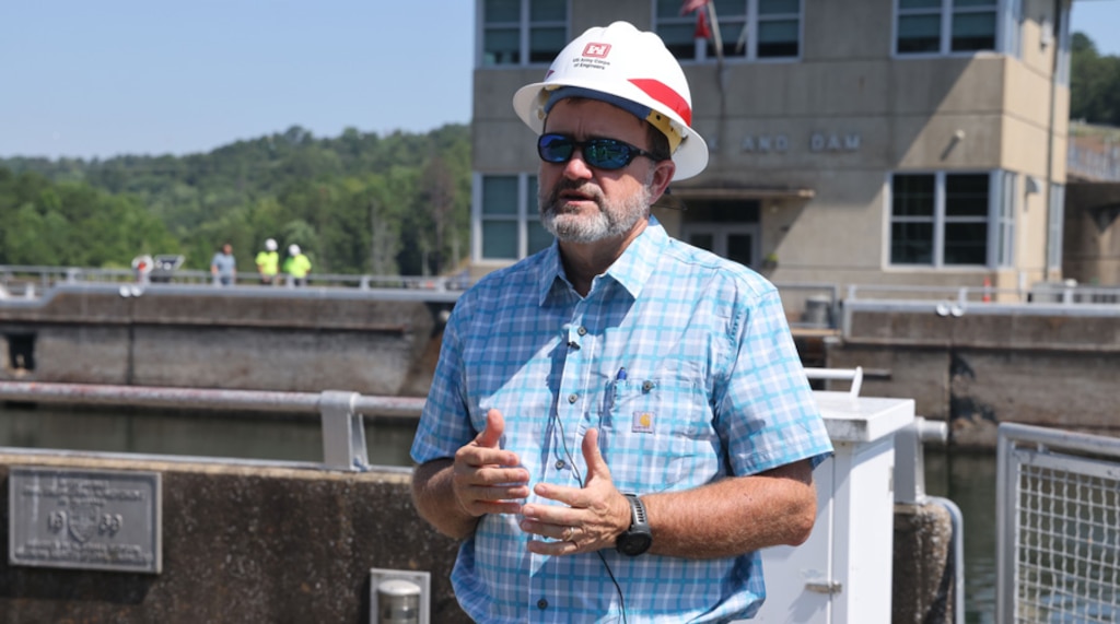 Man standing in front of a lock giving a press breifing.