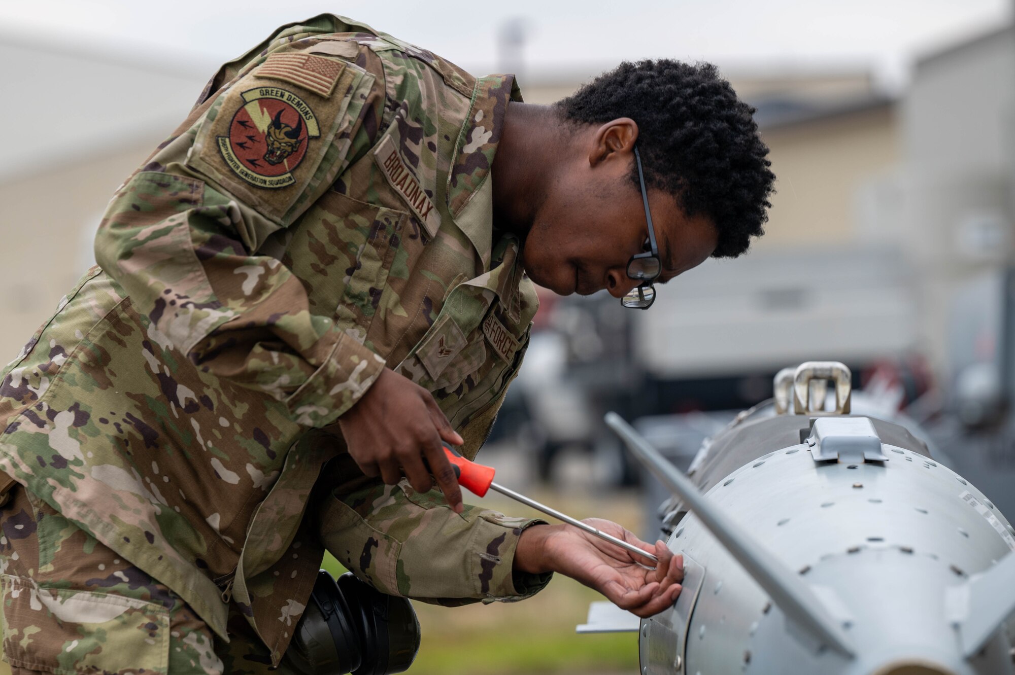 U.S. Air Force Airman 1st Class Nino Broadnax, 356th Fighter Generation Squadron load crew team member, uses a screwdriver on a piece of armament during a load competition at Eielson Air Force Base, Alaska, July 3, 2024.