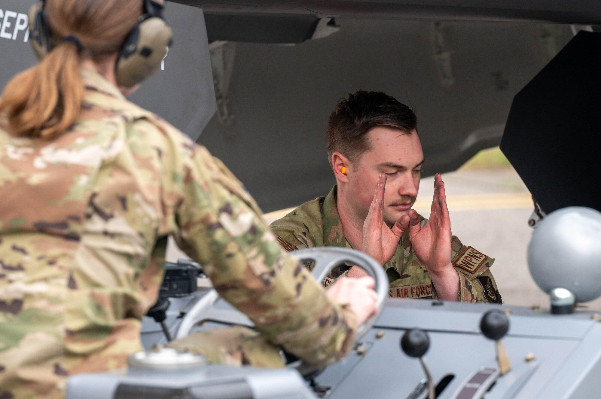 U.S. Air Force Staff Sgt. Nicholas Ecklund, 355th Fighter Generation Squadron load crew team chief, guides munitions for loading during a load competition at Eielson Air Force Base, Alaska, July 3, 2024.