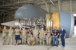 433rd Maintenance Group Reserve Citizen Airmen and civilian advisors pose for a group photo after the first removal of a General Electric F-138 jet engine from a C-5M Super Galaxy at the 433rd Airlift Wing on Joint Base San Antonio-Lackland, Texas June 28, 2024.