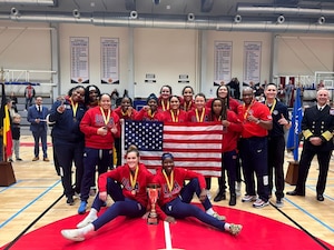 Women basketball players pose for a group photo.