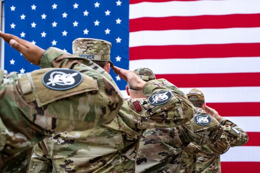  Uniformed military members render a salute during the change of command of space Delta 9.