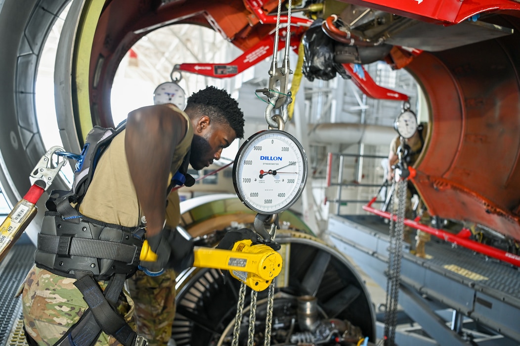 Senior Airman Evan Sherman, a 433rd Aircraft Maintenance Squadron aerospace propulsion technician, and several other 433rd Maintenance Group Reserve Citizen Airmen work together to lower a General Electric F-138 jet engine from a C-5M Super Galaxy at Joint Base San Antonio-Lackland, Texas June 28, 2024.