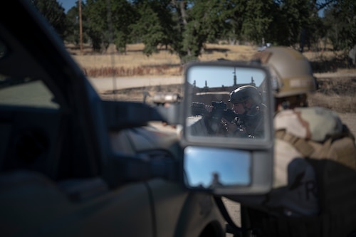 Airman 1st Class Olivia Dietz, 821st Contingency Response Squadron aerial porter specialist, takes aim amidst a simulated base attack during Exercise STORM CROW, at Fort Hunter-Liggett, California, June 26, 2024.