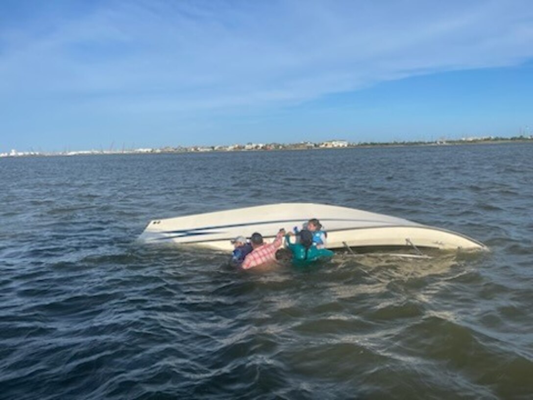 A 45-foot Response Boat–Medium crew from Coast Guard Station Freeport, surveys a capsized vessel near Galveston, Texas, July 4, 2024. After the crew rescued the people in the water, they transported them to the Galveston Bait Shop. (U.S. Coast Guard photo Courtesy Station Galveston)