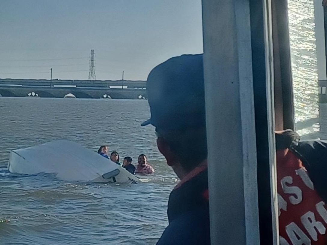 A 45-foot Response Boat–Medium crew from Coast Guard Station Freeport, surveys a capsized vessel near Galveston, Texas, July 4, 2024. After the crew rescued the people in the water, they transported them to the Galveston Bait Shop. (U.S. Coast Guard photo Courtesy Station Galveston)