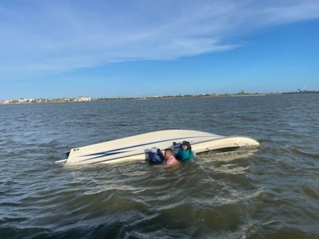 A 45-foot Response Boat–Medium crew from Coast Guard Station Freeport, surveys a capsized vessel near Galveston, Texas, July 4, 2024. After the crew rescued the people in the water, they transported them to the Galveston Bait Shop. (U.S. Coast Guard photo Courtesy Station Galveston)