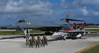 Members from the 37th Expeditionary Bomb Squadron pose with U.S. Marines in front of a B-1B Lancer and F/A-18D Hornet in support of Valiant Shield joint integration at Andersen Air Force Base, Guam, June 17, 2024. Valiant Shield ensures our Joint Force maintains its advantage against long-term competitors seeking to undermine the rules-based international order and the free and open Indo-Pacific that bolsters Indo-Pacific Security upon which global prosperity rests. (U.S. Air Force photo by Airman 1st Class Dylan Maher)