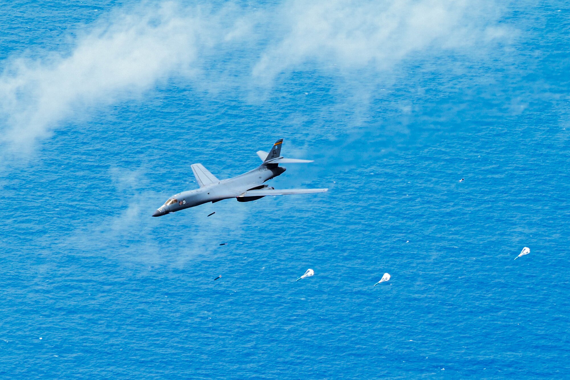 A B-1B Lancer assigned to the 37th Expeditionary Bomb Squadron deploys inert munitions during a full-scale mining exercise over the Philippine Sea, in support of a Bomber Task Force 24-6, June 18, 2024. The Air Force delivers airpower and has an essential role in maritime security operations. We use a variety of current platforms to present options to combatant commanders worldwide and will continue to provide this capability into the future. (U.S. Air Force photo by Airman 1st Class Dylan Maher)
