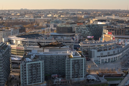 An Army VH-60M "gold top" Black Hawk helicopter flies near Washington Nationals Park in Washington, D.C.