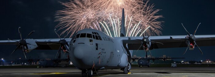 Fireworks explode behind a C-130J Super Hercules assigned to the 36th Airlift Squadron during the Celebrate America at Yokota Air Base, Japan.